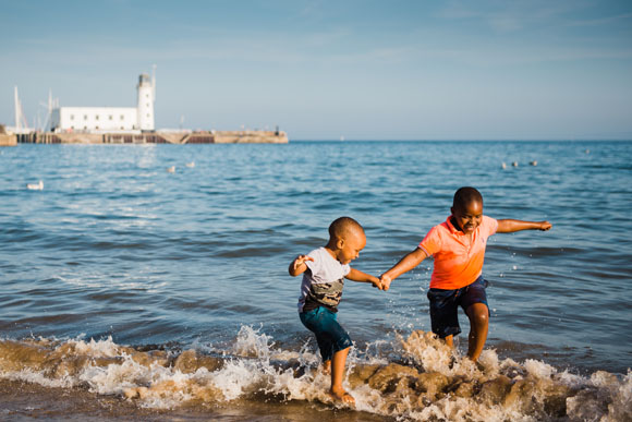 Flower of May boys playing at the beach